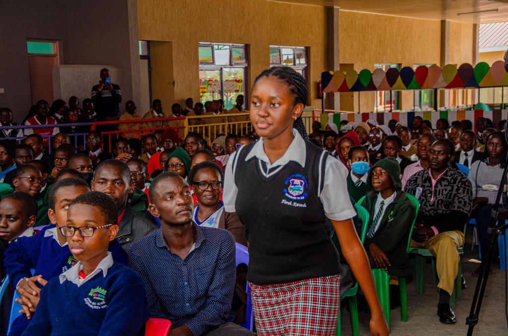 Large audience of students in school uniforms at the contest venue