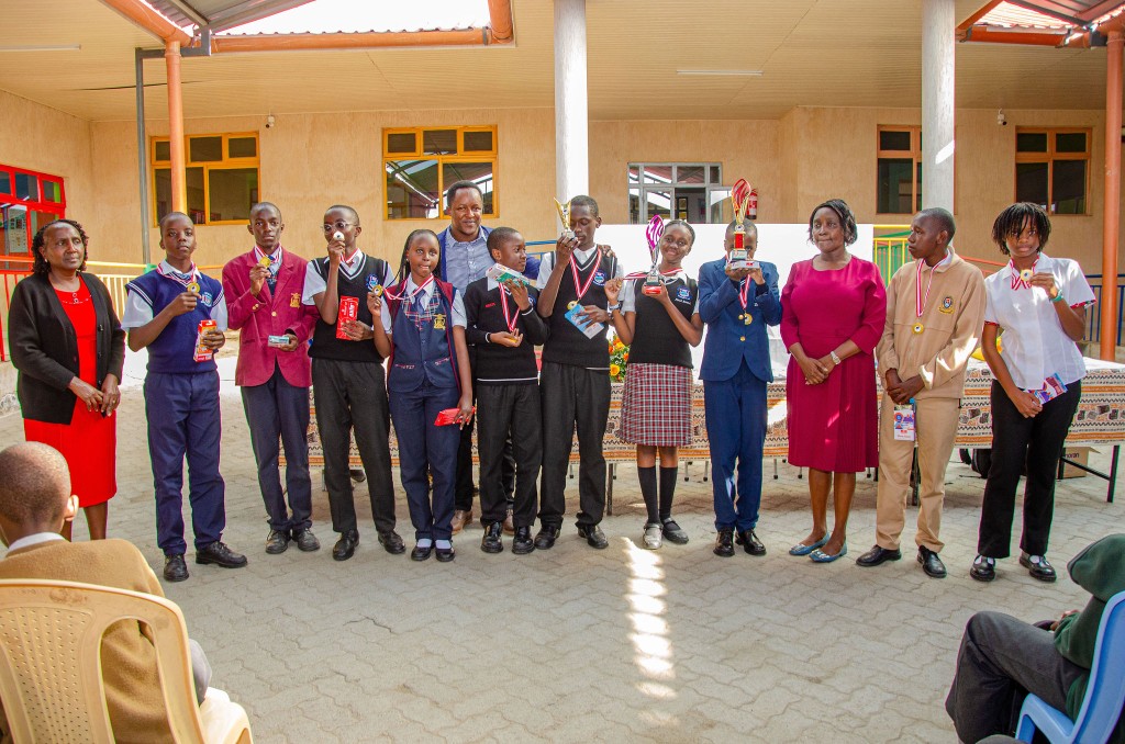 Students from multiple schools celebrating with trophies at the contest